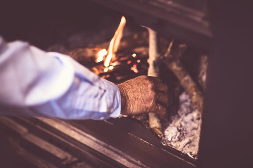 Man kindle a fire in the fireplace